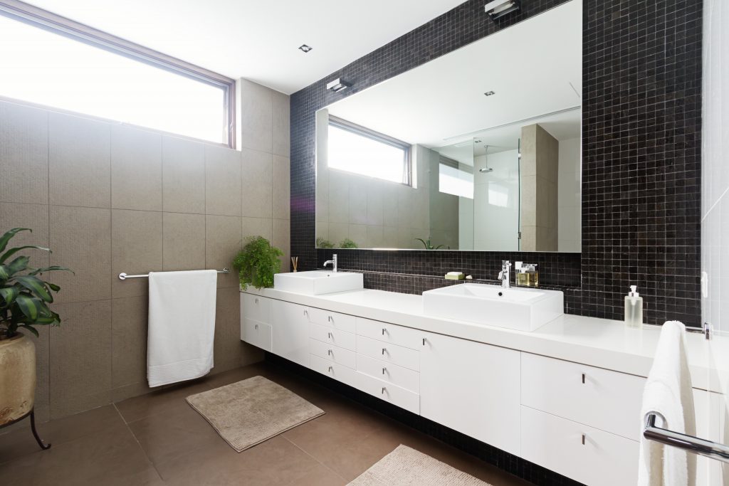 Black mosaic tiled splashback and double basin bathroom ensuite