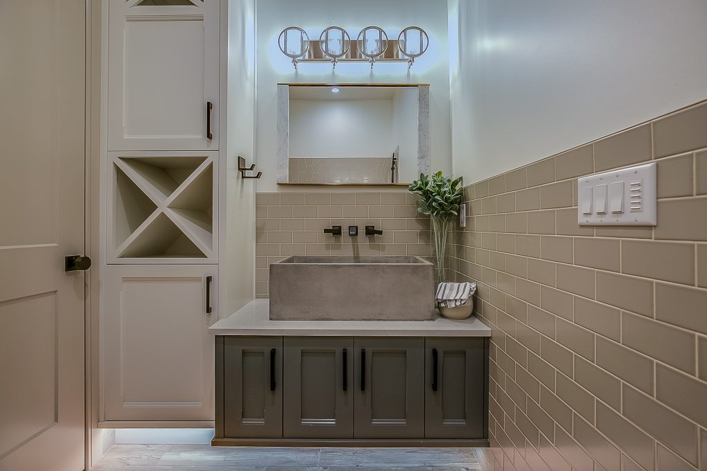 Walls with subway tile and storage cabinets for linens and such