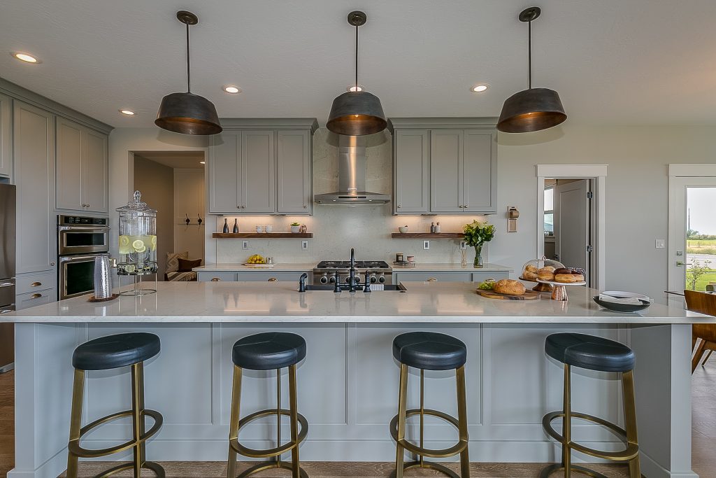 Kitchen island with gray and white colors staged for Tour